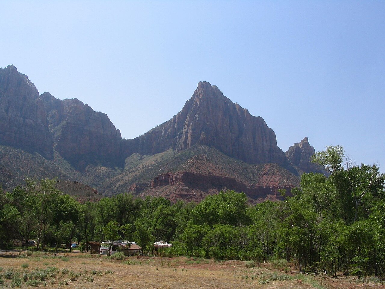The Watchman, a sandstone peak at the south end of Zion Canyon, above green cottonwoods near Springdale